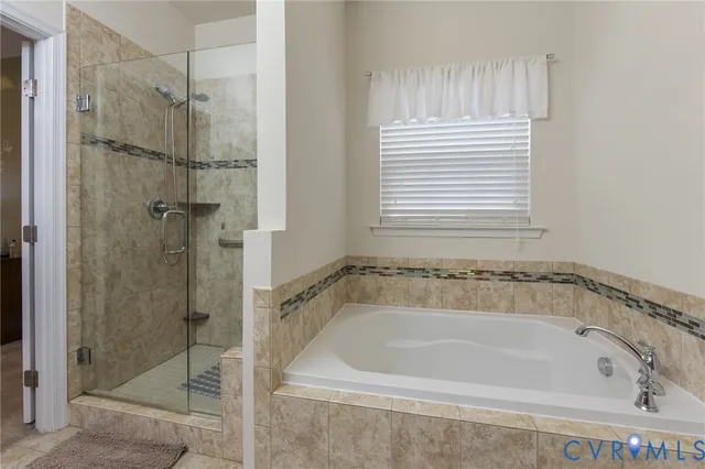 a white bath tub sitting next to a shower
