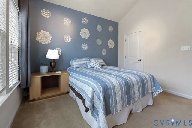 a bedroom with a bed and a lamp