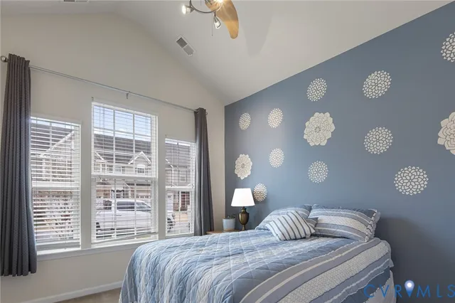 a bedroom with a bed and a large window