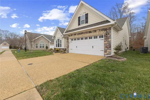 a view of a big house with a big yard and large tree