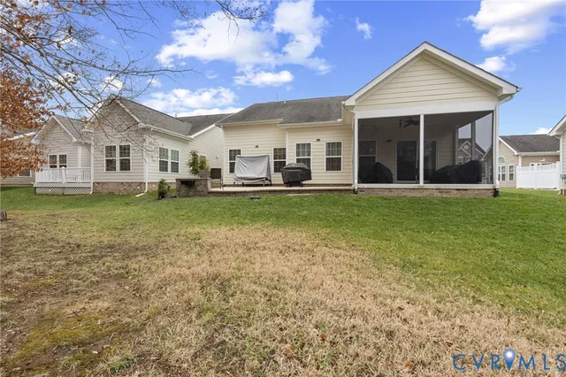 a view of a house with a big yard and large trees