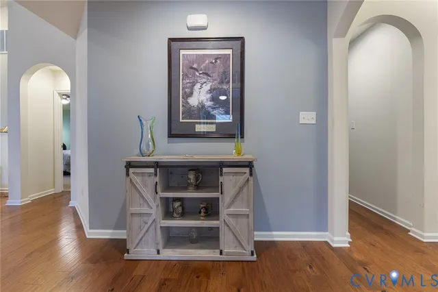 a room with painting on wall and a wooden floor