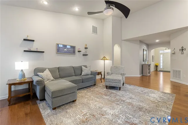 a living room with furniture and a wooden floor