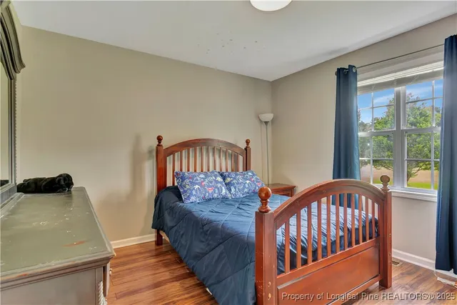 a bedroom with furniture and a window