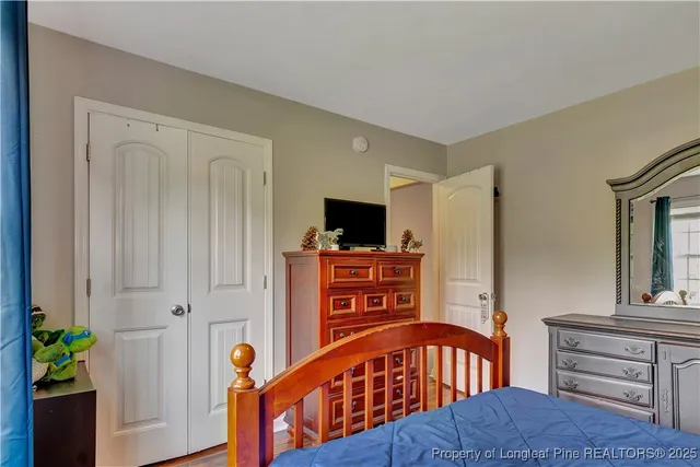 a bedroom with furniture and a flat screen tv