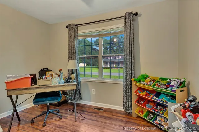 a workspace with furniture and a wooden floor