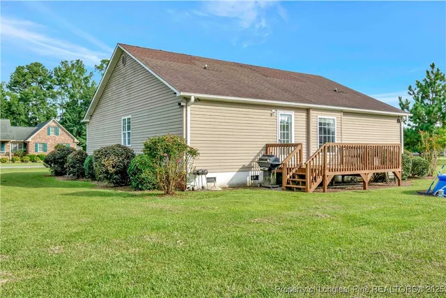 a view of a house with yard and sitting area