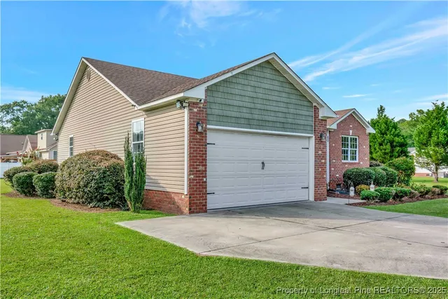 a view of a house with a yard and garage