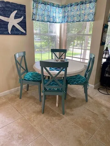 a view of a dining room with furniture window and outside view