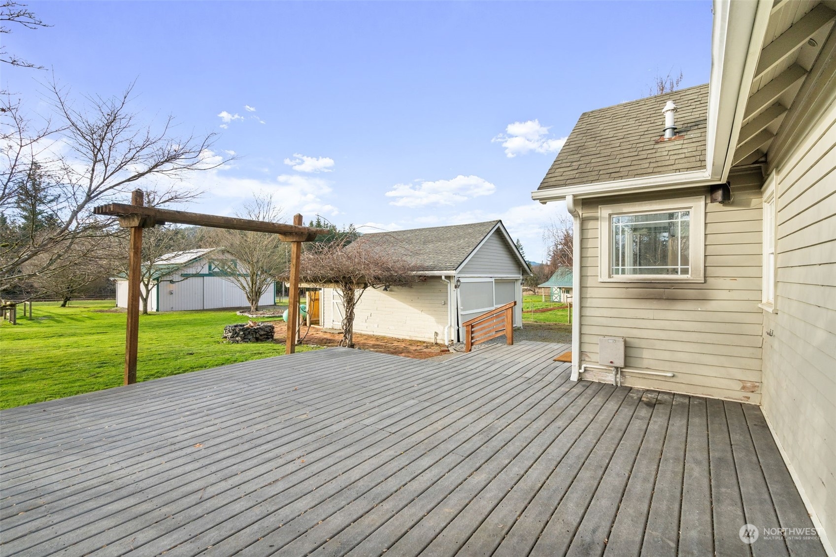 2628 Old Highway 99 North Road Burlington, WA 98233 - Photo 22 of 40 a view of a house with wooden deck and trees