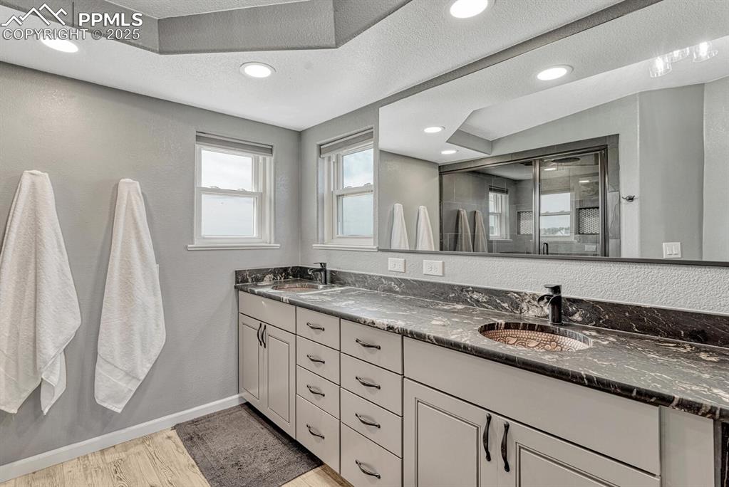 15371 Buck Creek Road Elbert, CO 80106 - Photo 11 of 50 a bathroom with a granite countertop sink and a mirror
