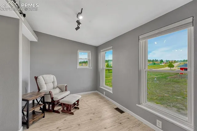 a view of workspace with wooden floor windows