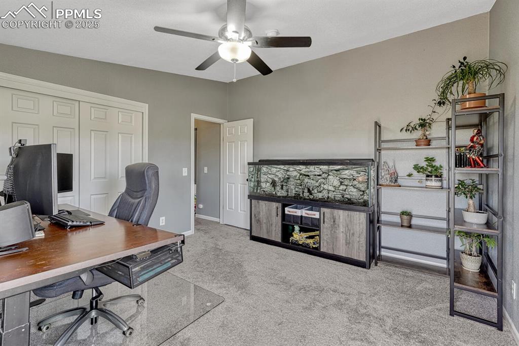 15371 Buck Creek Road Elbert, CO 80106 - Photo 17 of 50 a work room with furniture and a fireplace