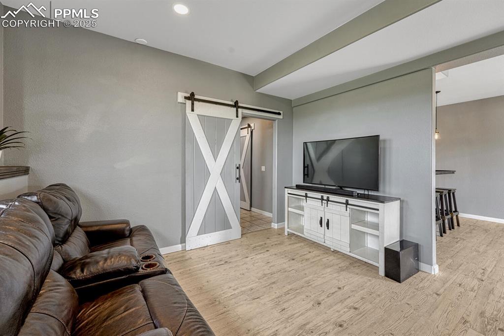 15371 Buck Creek Road Elbert, CO 80106 - Photo 20 of 50 a living room with furniture and a flat screen tv