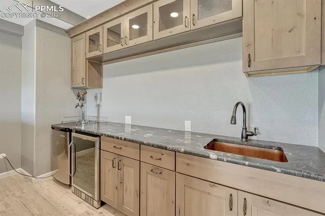 a kitchen with granite countertop a table chairs stove and cabinets