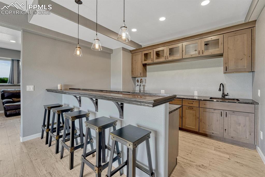 15371 Buck Creek Road Elbert, CO 80106 - Photo 25 of 50 a kitchen with granite countertop a table chairs stove and cabinets