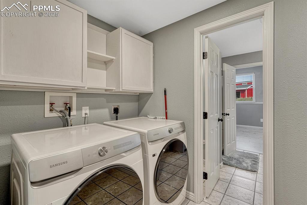 15371 Buck Creek Road Elbert, CO 80106 - Photo 29 of 50 a utility room with dryer and washer