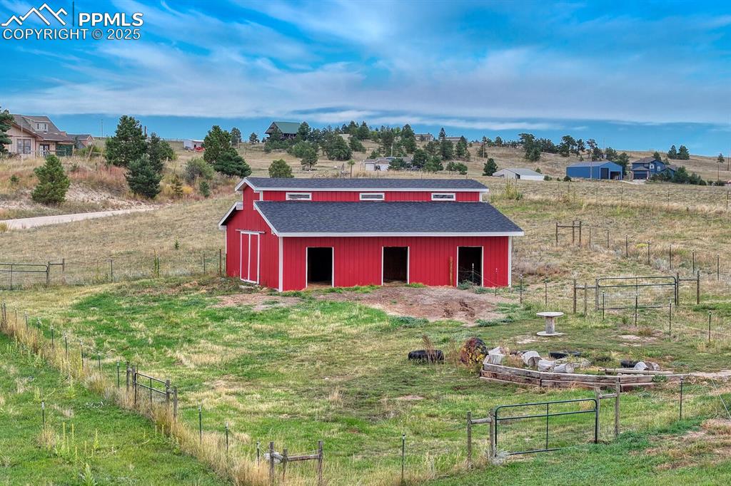 15371 Buck Creek Road Elbert, CO 80106 - Photo 36 of 50 a view of a house with a yard