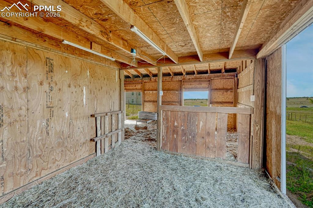 15371 Buck Creek Road Elbert, CO 80106 - Photo 39 of 50 a view of a empty room with wooden walls