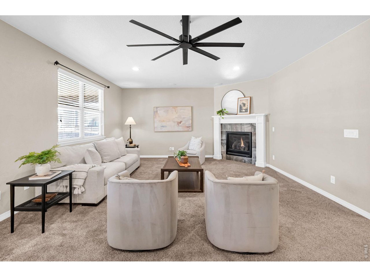 6028 Moran Road Timnath, CO 80547 - Photo 12 of 49 a living room with furniture a fireplace and a flat screen tv