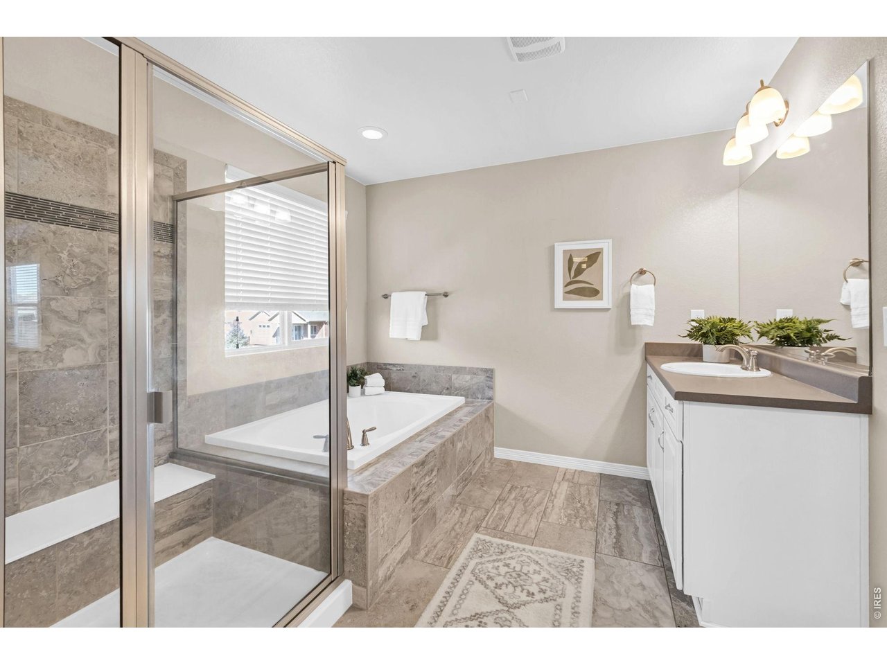 6028 Moran Road Timnath, CO 80547 - Photo 18 of 49 a bathroom with a sink a mirror and a bathtub