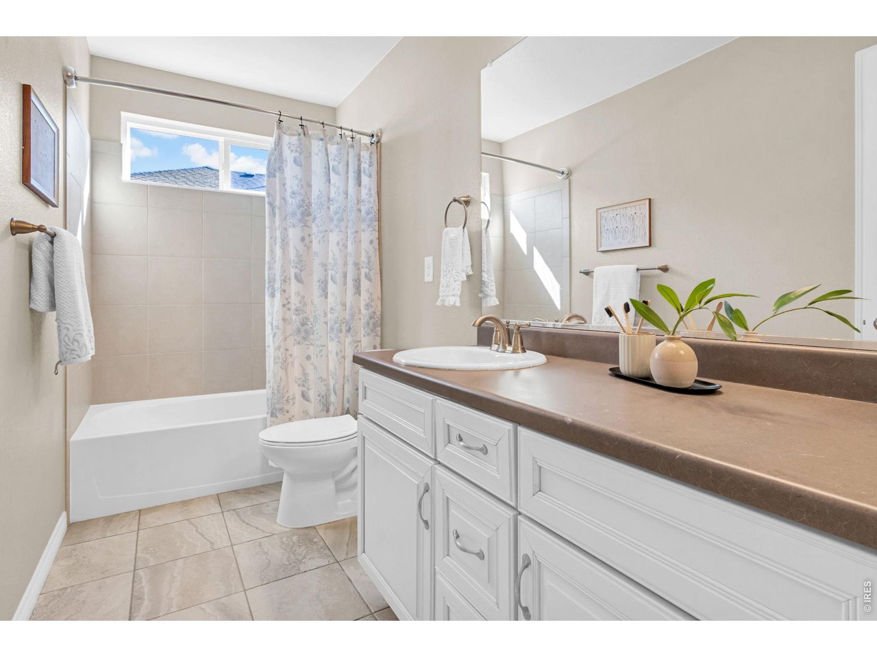 6028 Moran Road Timnath, CO 80547 - Photo 27 of 49 a bathroom with a double vanity sink toilet and shower