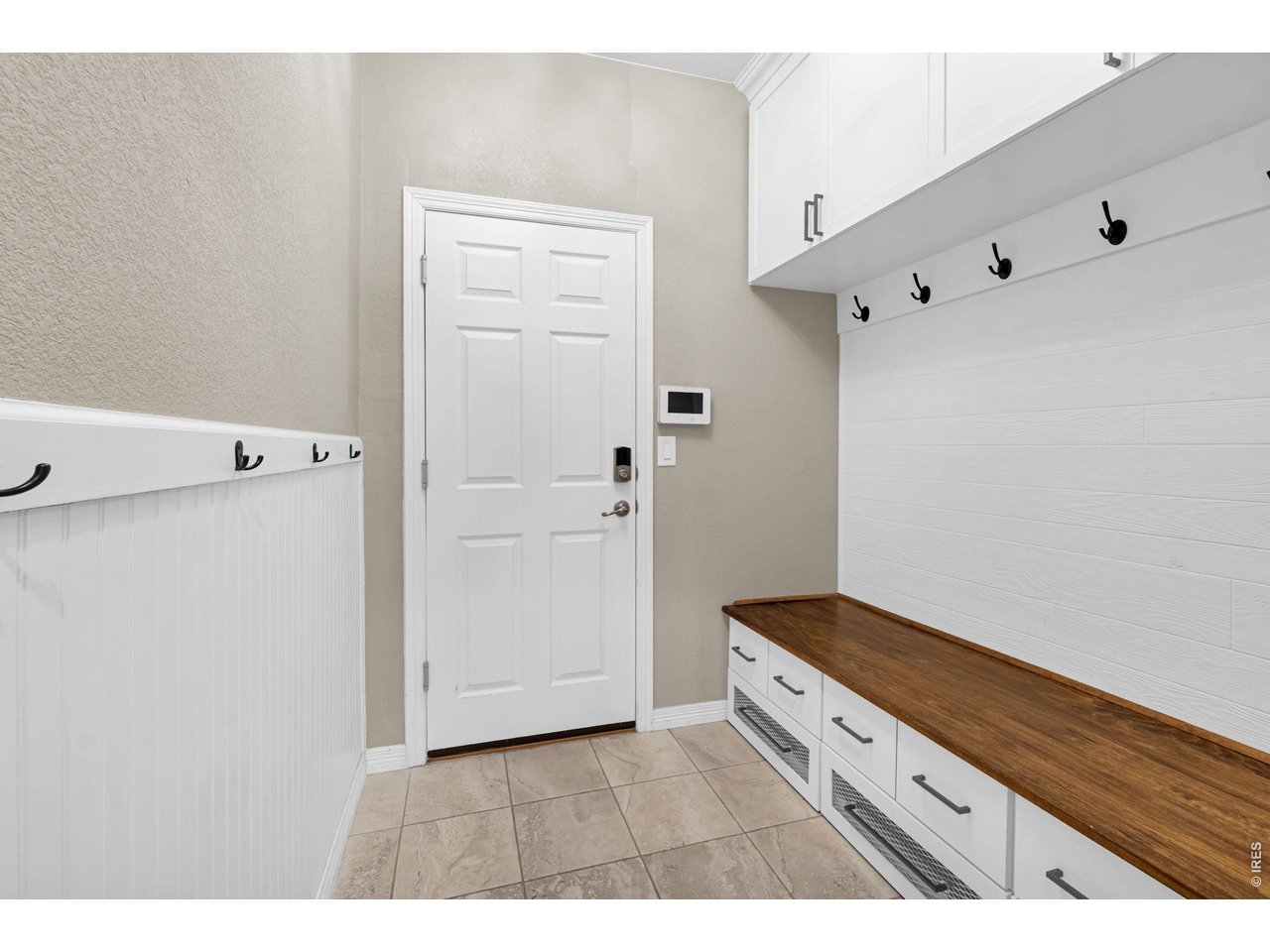 6028 Moran Road Timnath, CO 80547 - Photo 32 of 49 a kitchen with white cabinets and white appliances