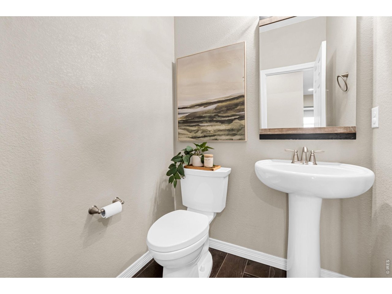 6028 Moran Road Timnath, CO 80547 - Photo 33 of 49 a bathroom with a sink a toilet and mirror