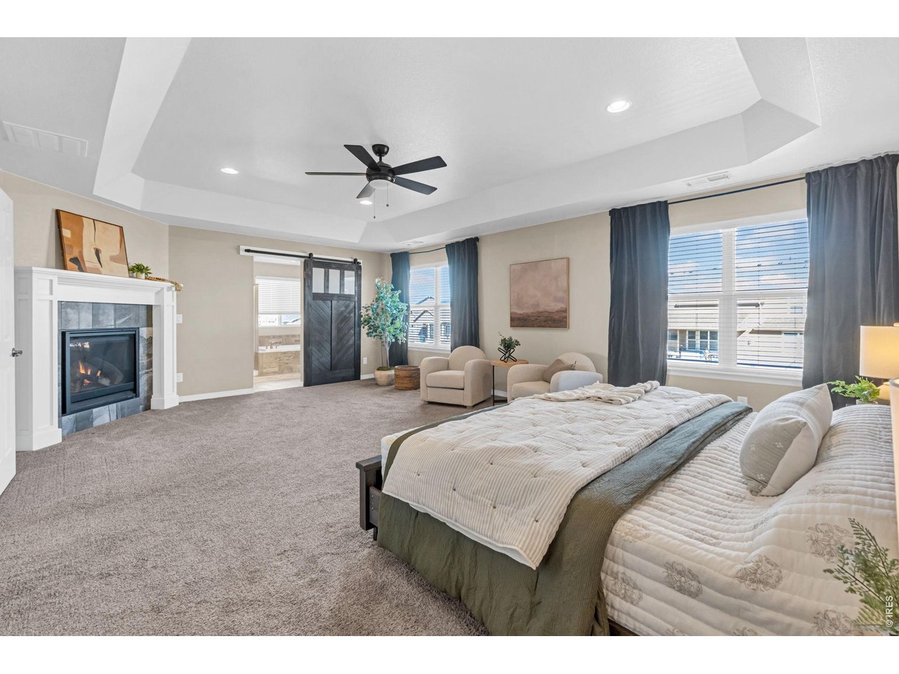 6028 Moran Road Timnath, CO 80547 - Photo 9 of 49 a spacious bedroom with a large bed and a chandelier