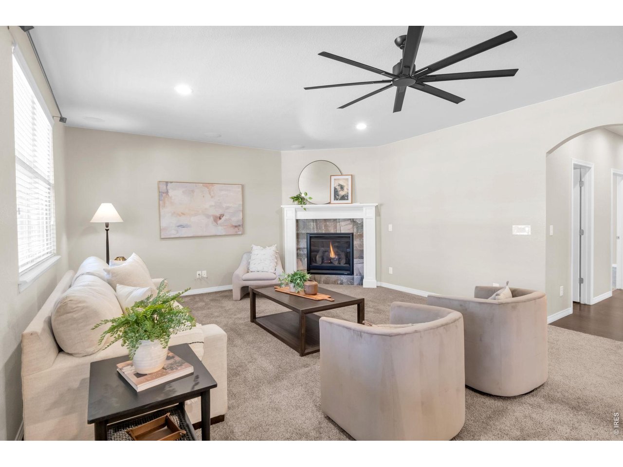 6028 Moran Road Timnath, CO 80547 - Photo 10 of 49 a living room with furniture a fireplace and a ceiling fan