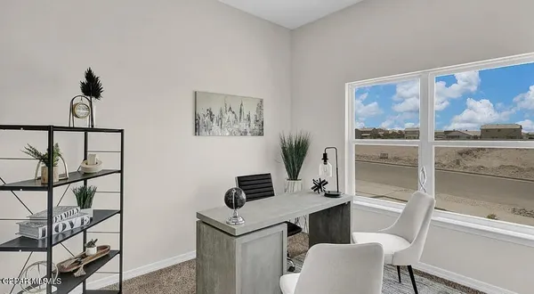 a work room with furniture and large window