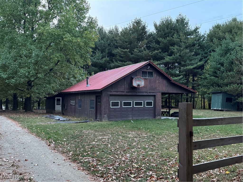 2360 Scio Road Carrollton, OH 44615 - Photo 19 of 22 View of front facade featuring a front yard, a garage, and an outbuilding