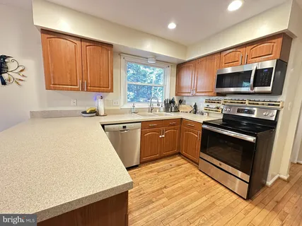 a kitchen with stainless steel appliances a sink dishwasher stove and microwave