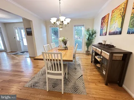 a view of a dining room with furniture wooden floor and chandelier