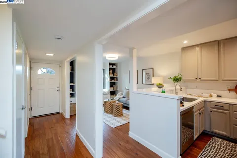 a kitchen with a sink a stove and cabinets