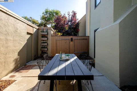 a large bedroom with a bed and a potted plant