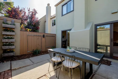 a large bedroom with a bed and a potted plant
