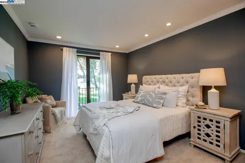 a bedroom with two beds and a chandelier