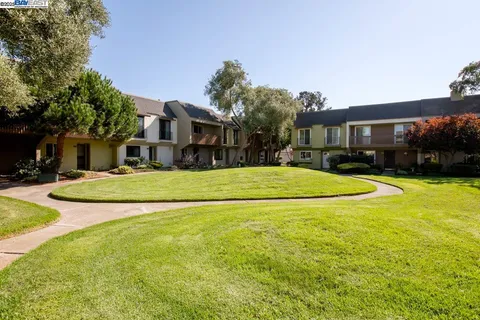 a living room with furniture a fireplace and a large mirror