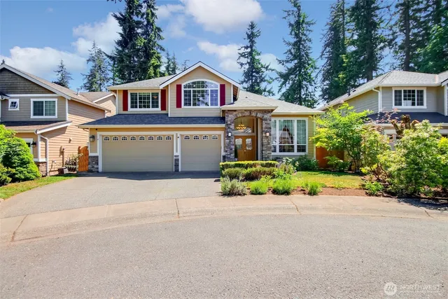 a front view of a house with a yard and potted plants