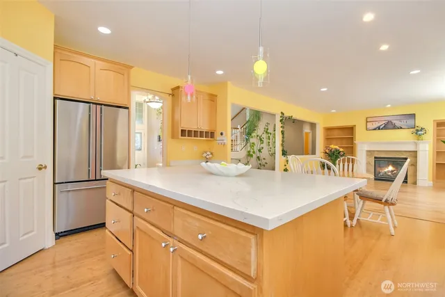 a dining room with furniture a fireplace and wooden floor