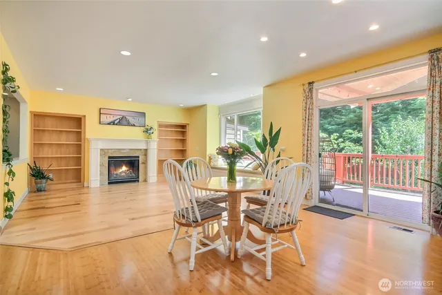 a view of an empty room with a fireplace and a window