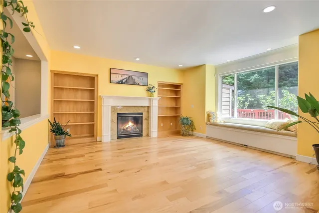 a view of a living room filled with furniture and a large window