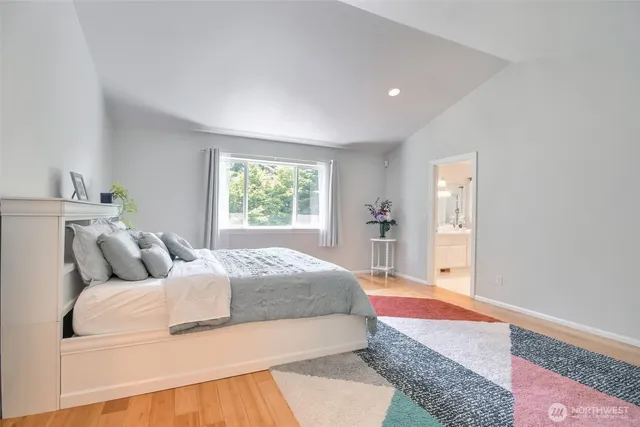 a bed sitting in a bedroom next to a window