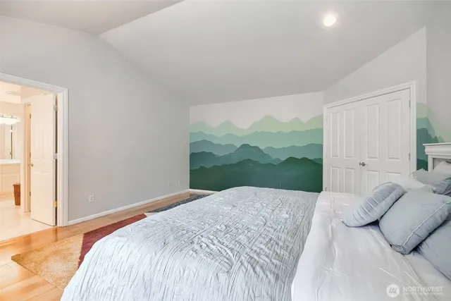 a bathroom with a tub a sink double vanity and a mirror