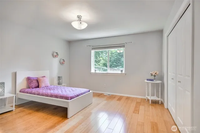 a view of a bedroom with a bed and a chandelier fan