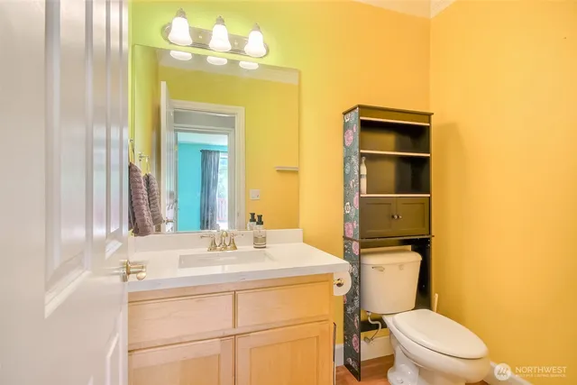 a bathroom with a sink mirror and vanity
