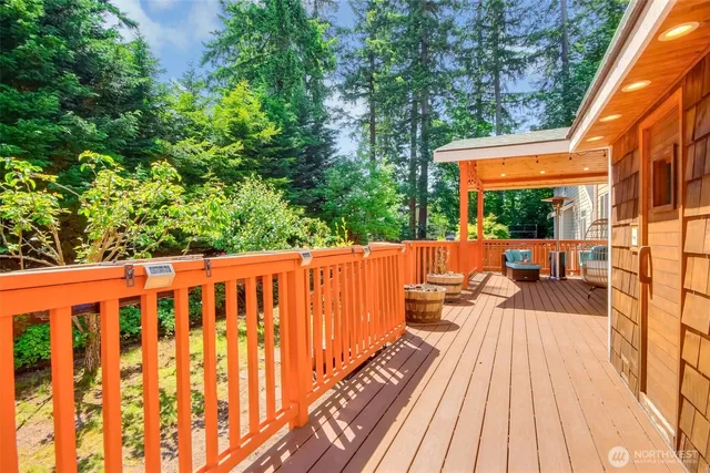 a balcony with wooden floor table and chairs