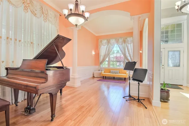 a view of entryway and hall with wooden floor