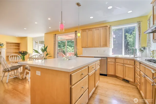 a kitchen with stainless steel appliances granite countertop a sink and a white cabinets
